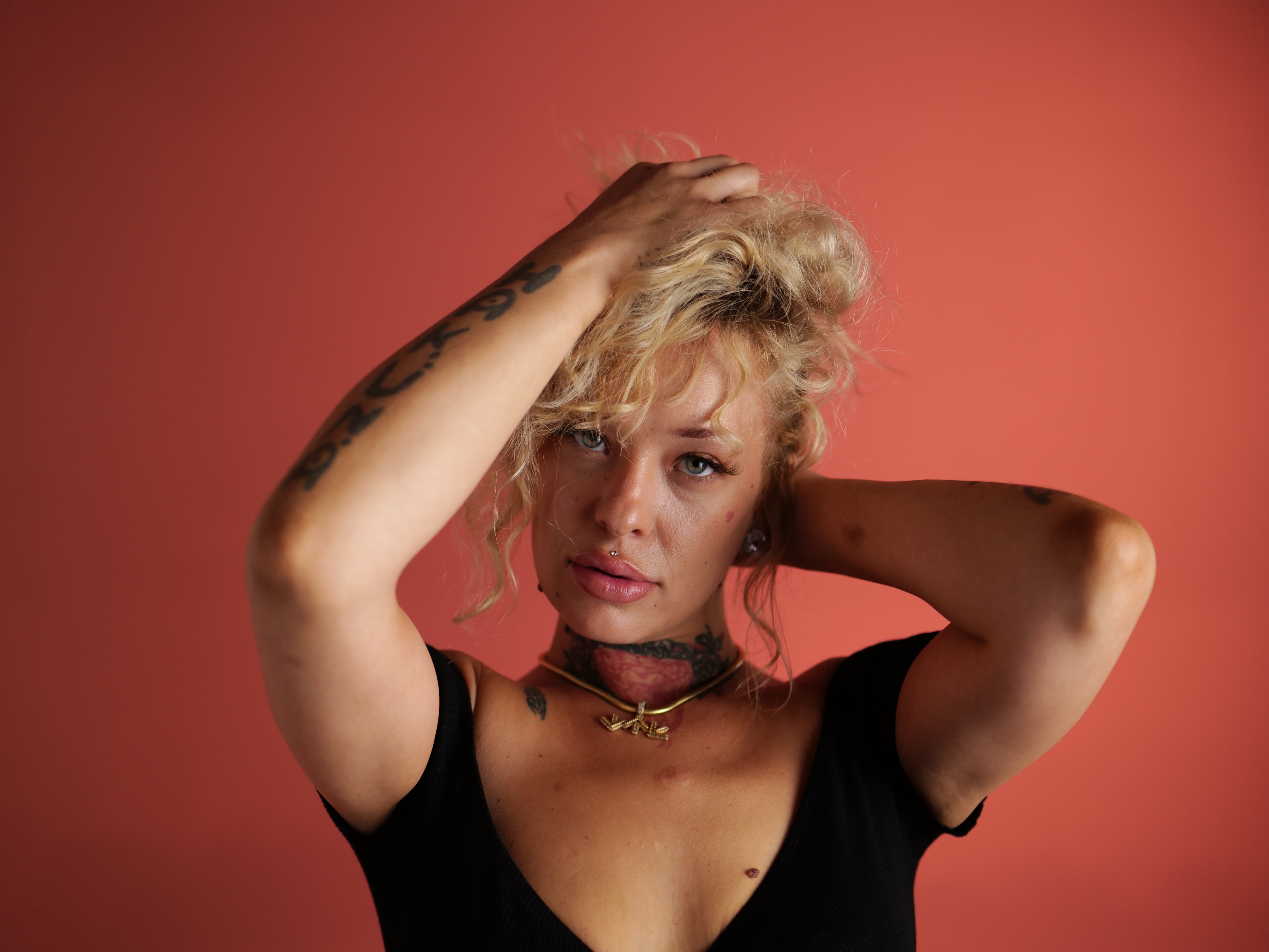 South North Southwest studio portrait on a coral-red backdrop