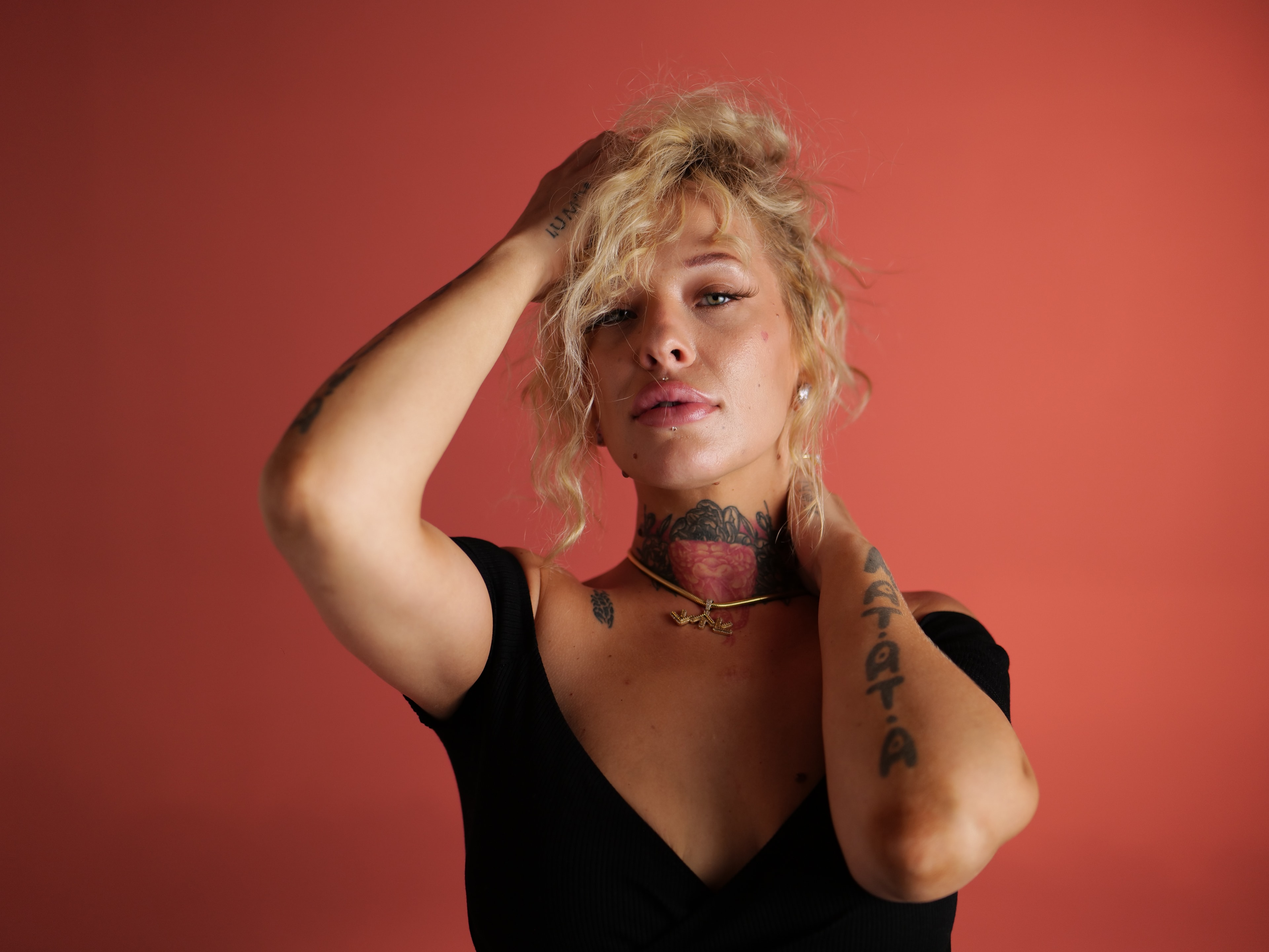 South North Southwest studio portrait on a coral-red backdrop
