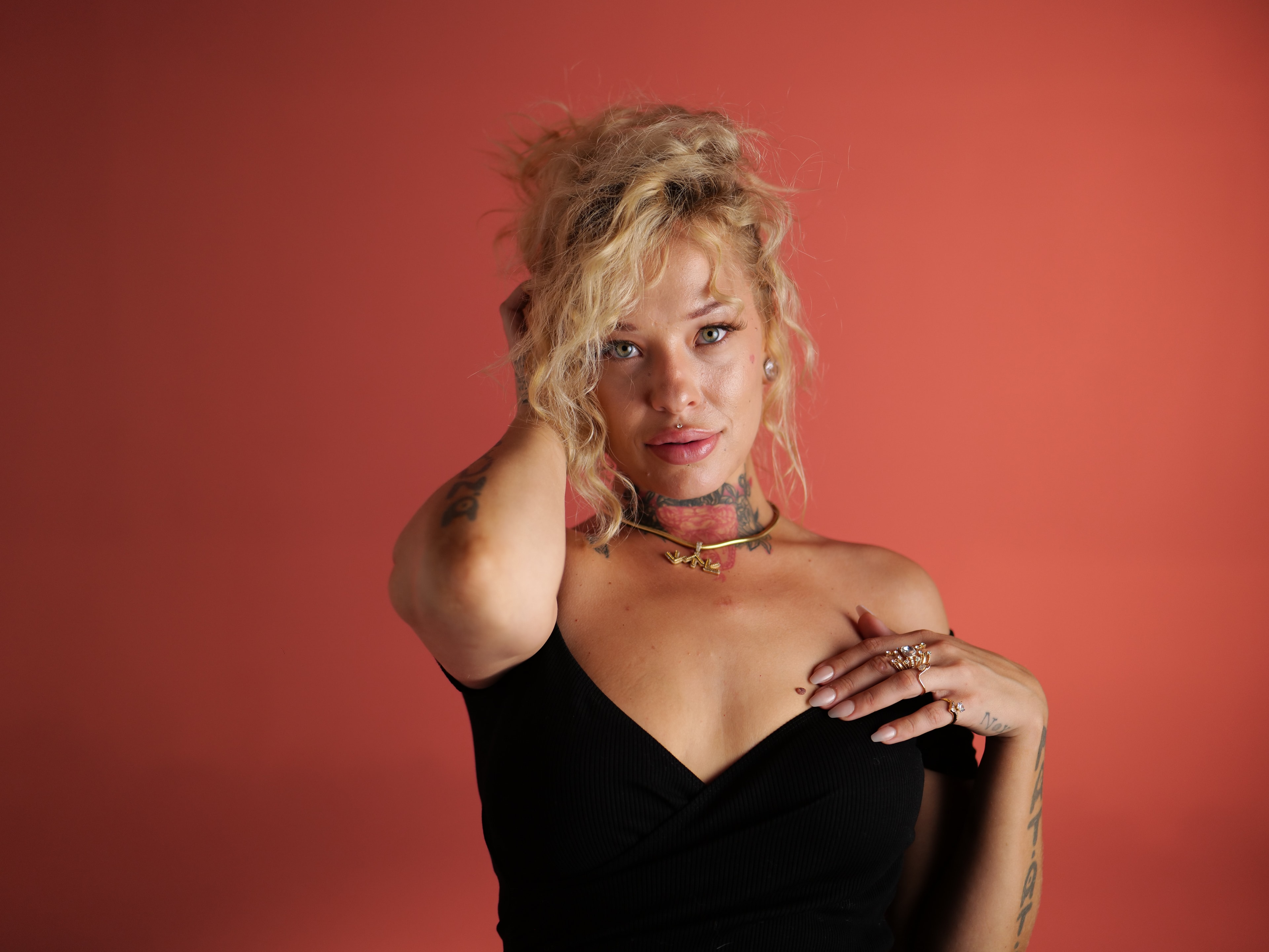 South North Southwest studio portrait on a coral-red backdrop